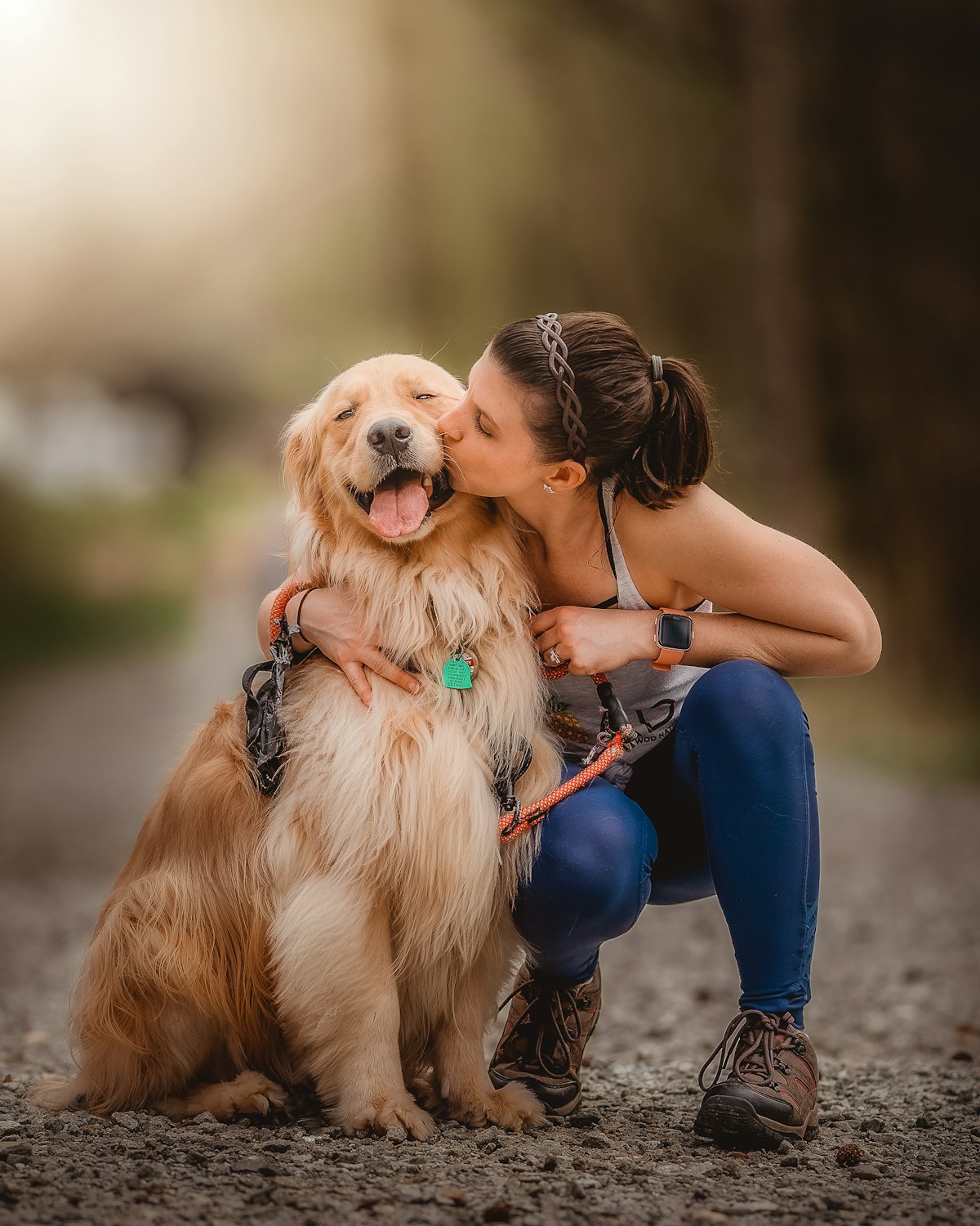 Woman hugging her golden retriever outdoors