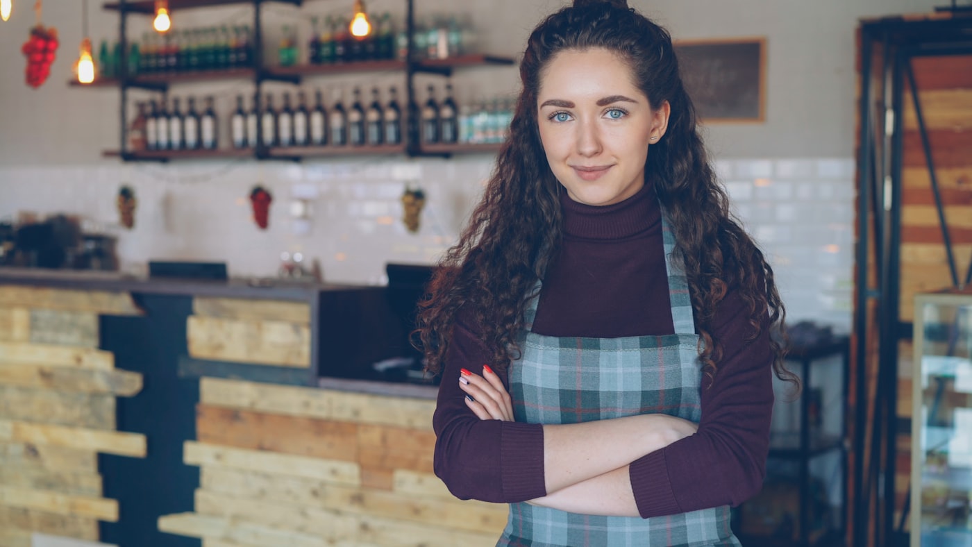 Confident small business owner standing in her shop